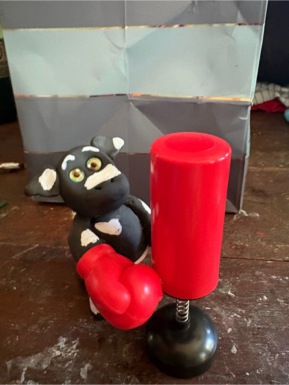 Handcrafted Black and Red Boxing Cow Figurine with Punching Bag